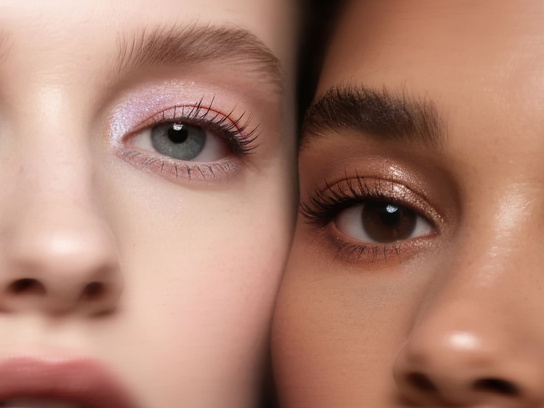 Close-up of purple metallic Illumina eyeshadow on an eyelid with a clean under-eye area.  