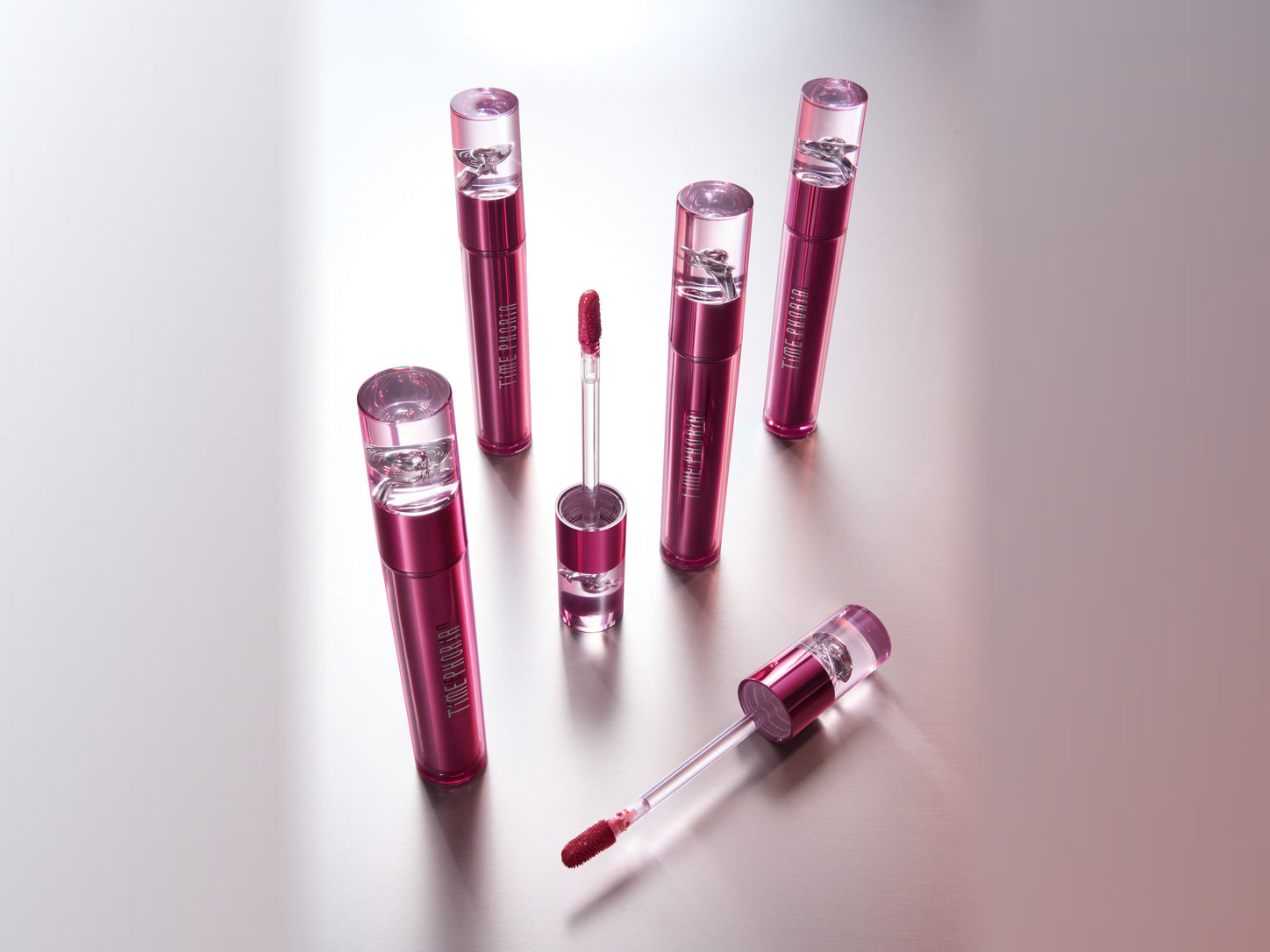 Altera Blurring Lip Tint with applicator beside lips wearing a soft-focus velvet matte finish.