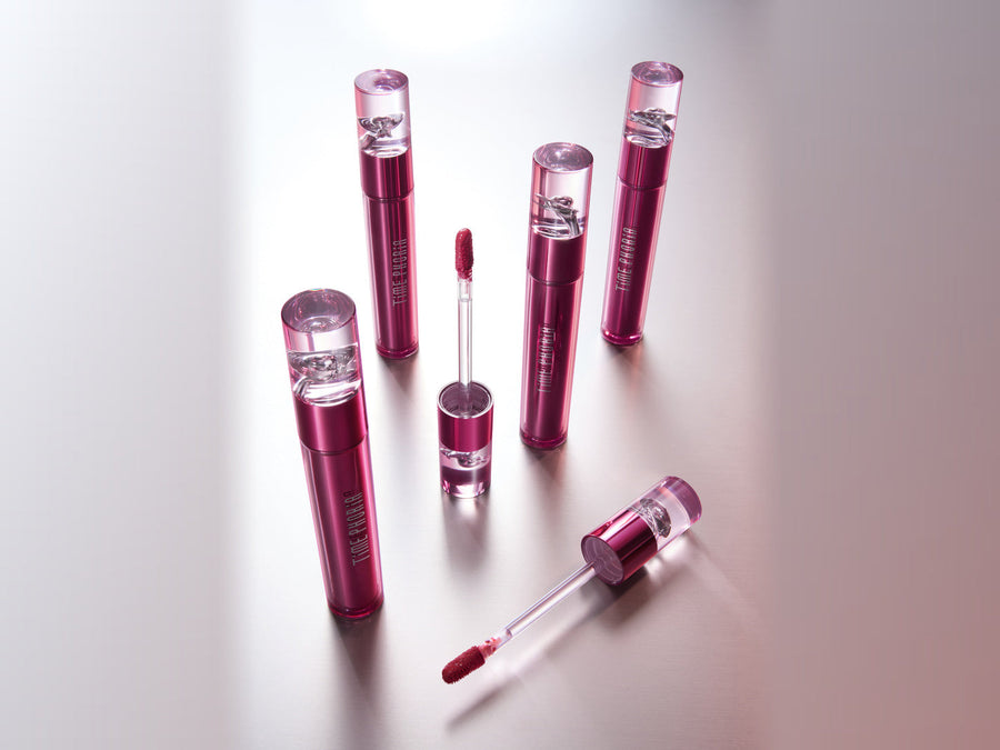 Altera Blurring Lip Tint with applicator beside lips wearing a soft-focus velvet matte finish.