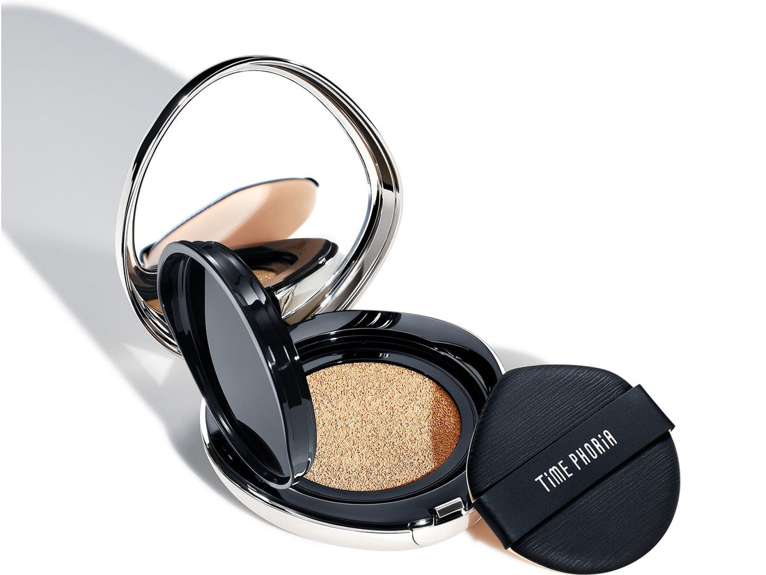 Open TimePhoria cushion foundation compact showing the foundation-soaked sponge and a black makeup puff.